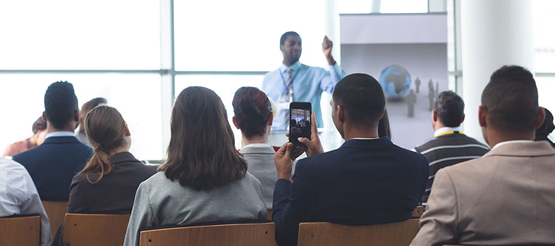 Photo of a brightly light room with a single speaking a